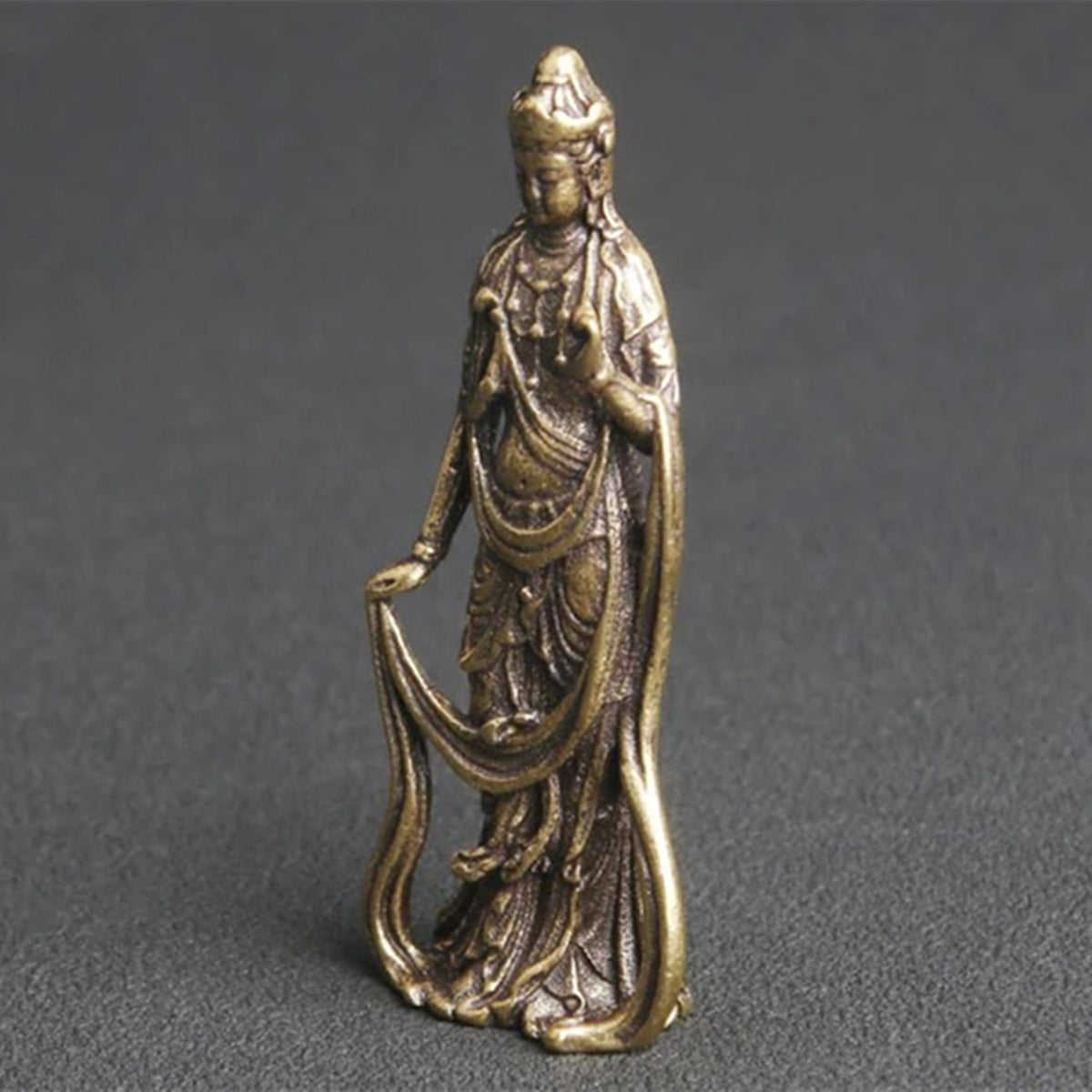 Hand-carved vintage solid copper Guanyin Buddha figurine by Thai artisan, perfect for watch accessory display.