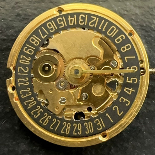 Swiss Made ETA 256.041 quartz watch movement with black dial and date at 6 o'clock, sleek design.