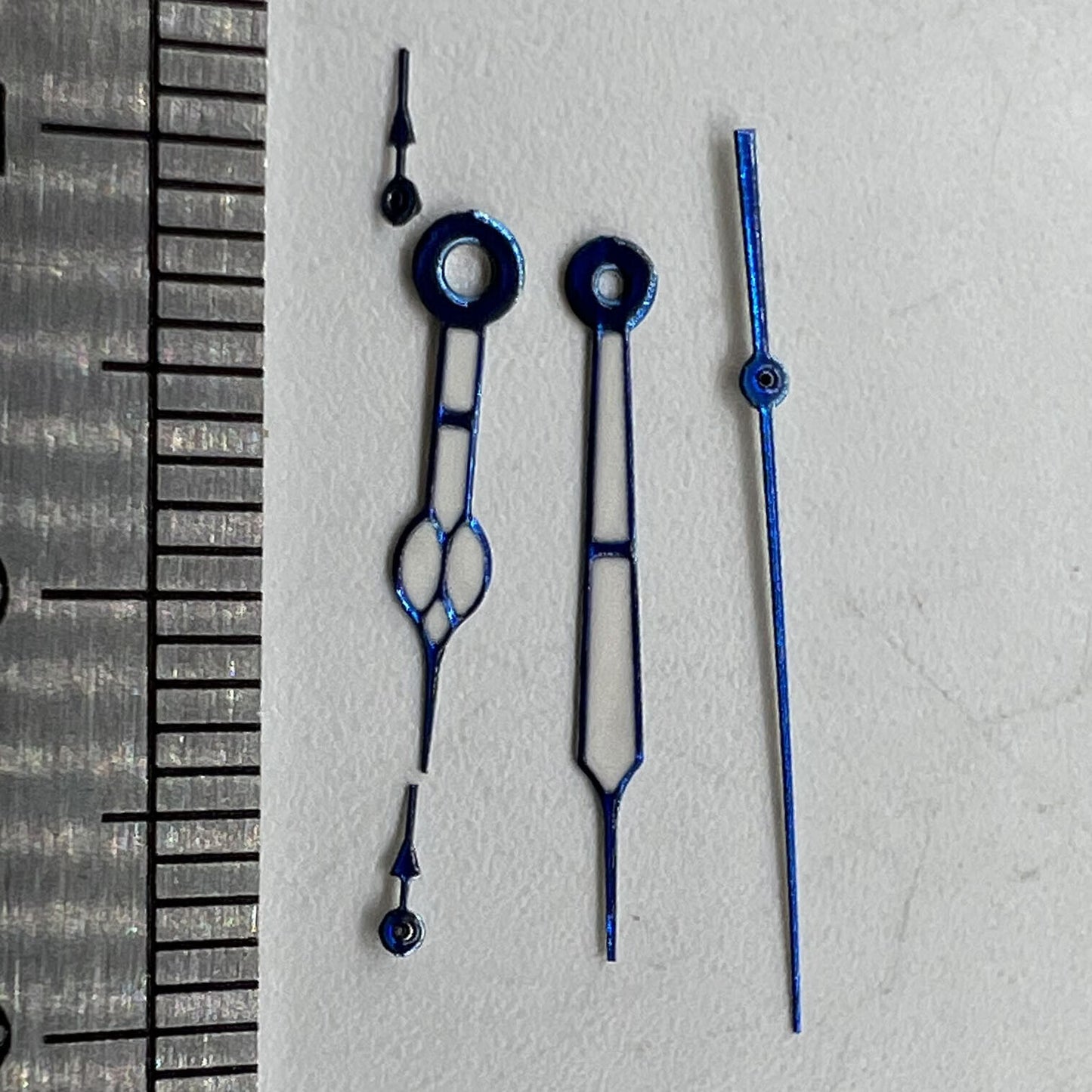 Blue trimmed watch hands with green lume for Miyota OS10 movement, precise fit and luminous glow.