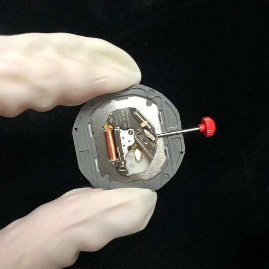 Quartz watch movement Miyota 2453 with date at 3 o'clock and watch stem for precise timekeeping.