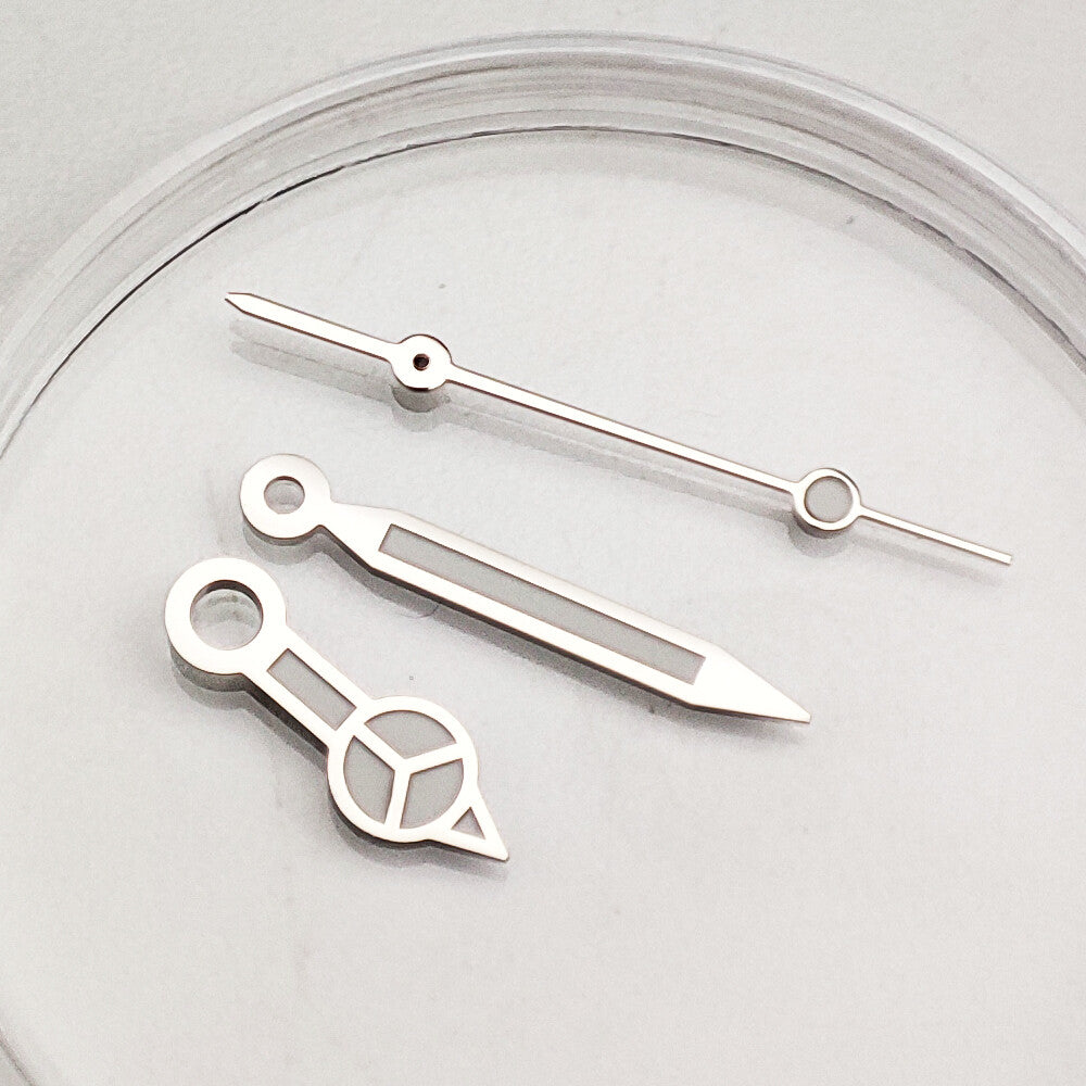 Silver-trimmed green luminous watch hands for NH35A/NH36A movement, enhancing readability and style by Orient.
