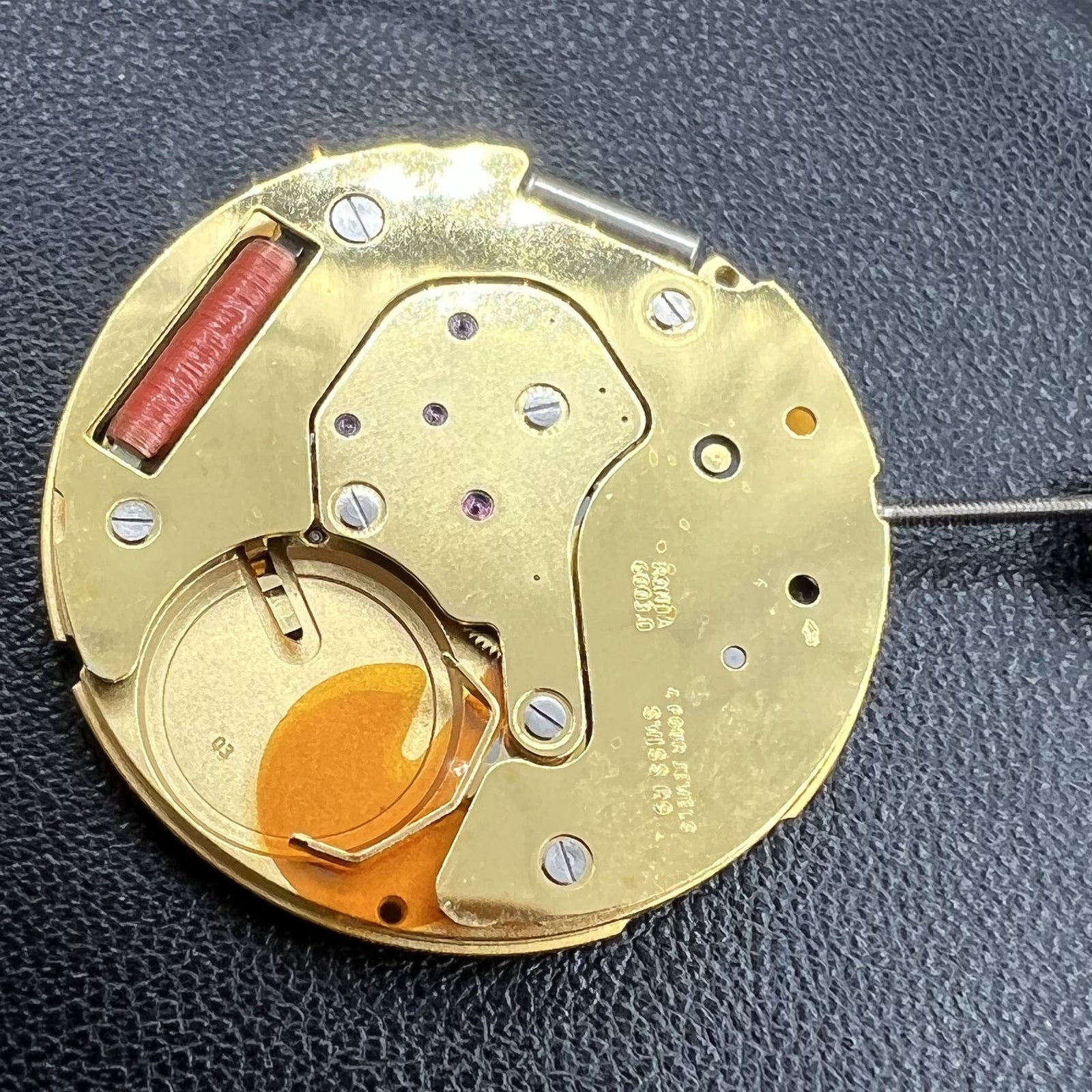 Swiss Ronda 6003.D quartz watch movement with 3 hands and single calendar on black dial.