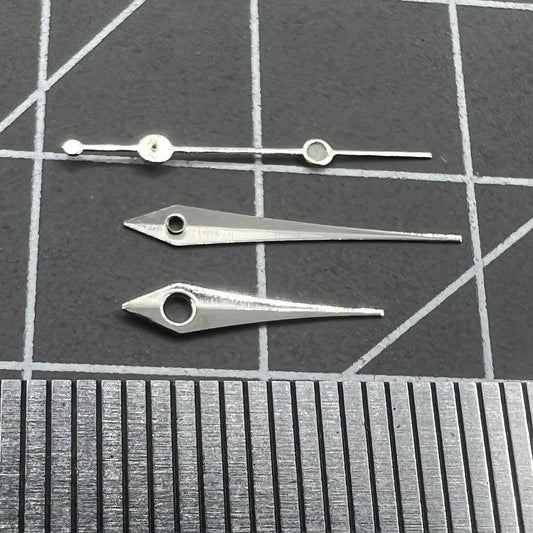 Silver 13mm arrow-shaped watch hands set by Trim, designed for Ronda 515 quartz movement timepieces.
