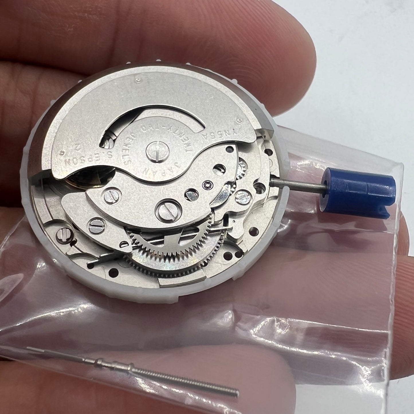 Epson YN56 watch movement displaying mechanical date and day functions, precision Japanese design.