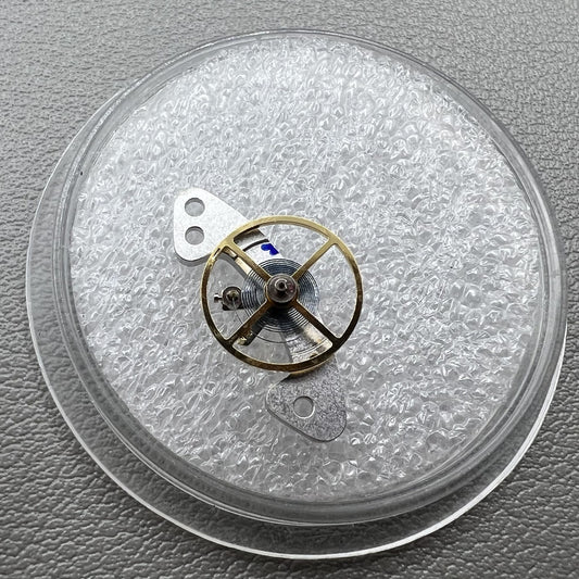 Blue mainspring mounted on complete balance wheel for Dandong 4130 mechanical watch movement.