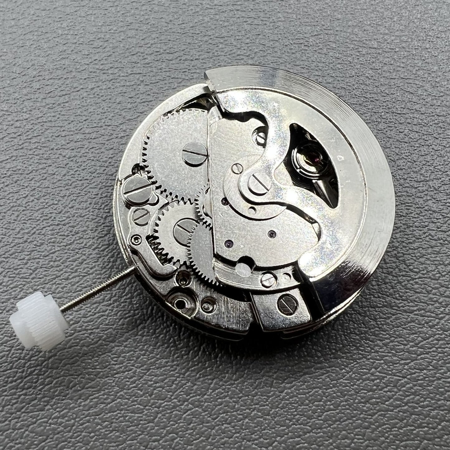 7120 Hollow silver automatic watch movement displaying intricate mechanical gears and expert craftsmanship.