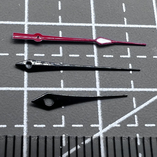 Set of 16mm black and red trim watch hands with green lume, compatible with Ronda 515 movement.