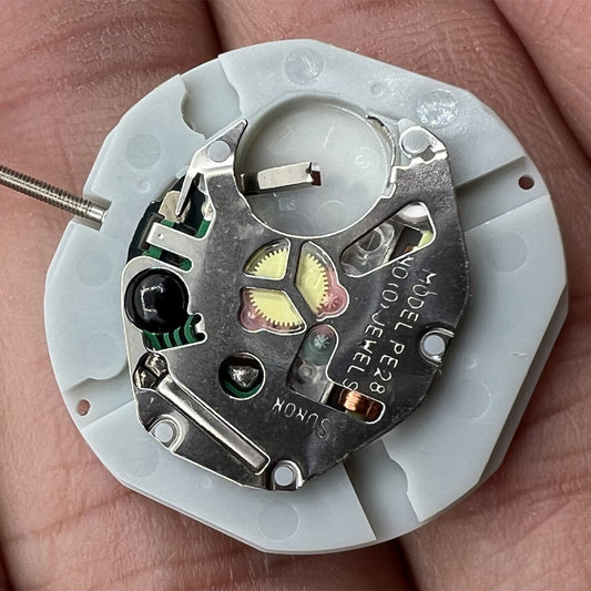 Sunon PE28 quartz watch movement with 3 hands and date at 3, replacement for precise timekeeping.