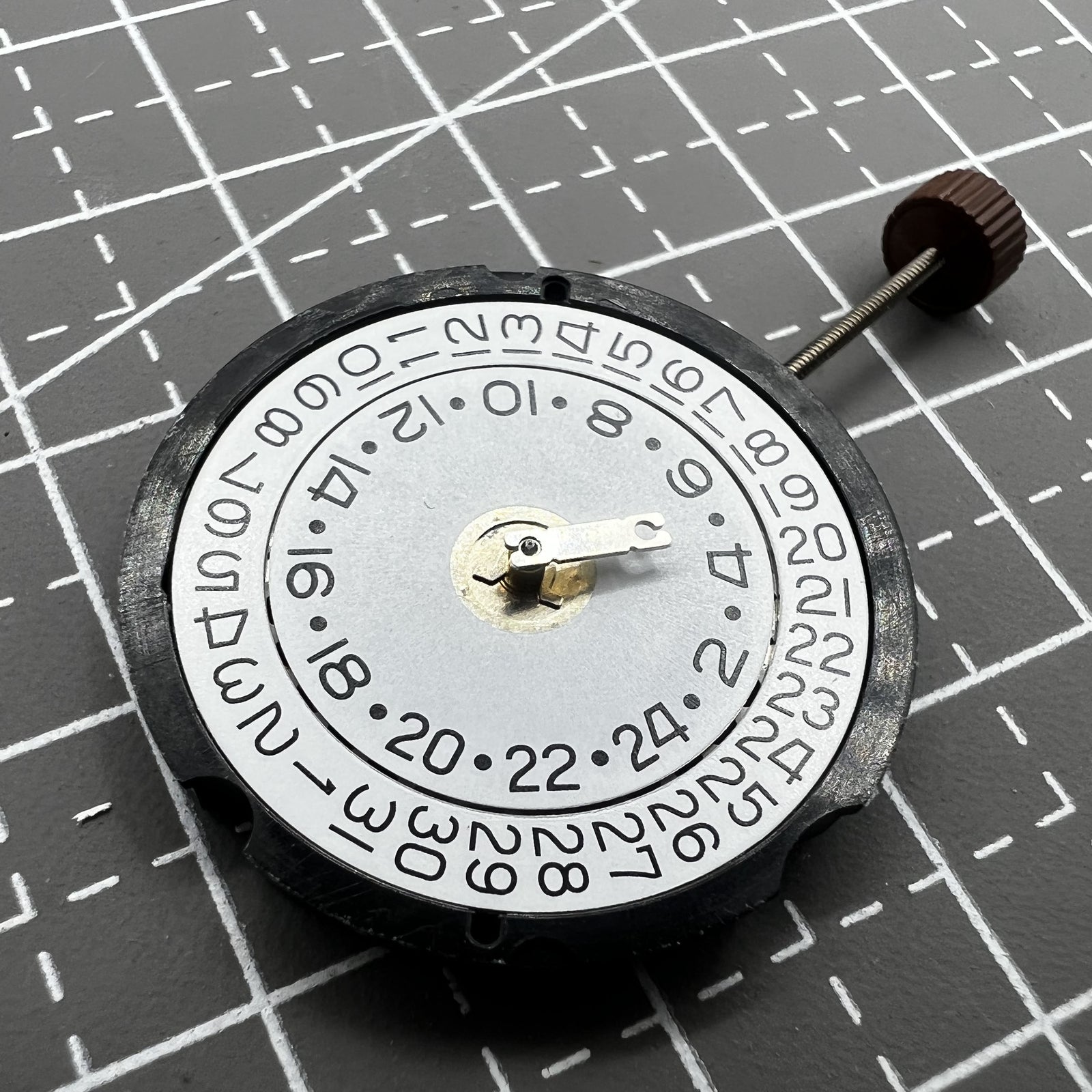 Ronda 505 24D quartz watch movement with date display at 3 o'clock, precise timekeeping mechanism.