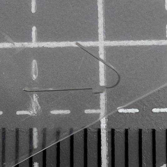 Close-up of disassembled self-winding spring click for ETA C01.211 movement, precision watch accessory.