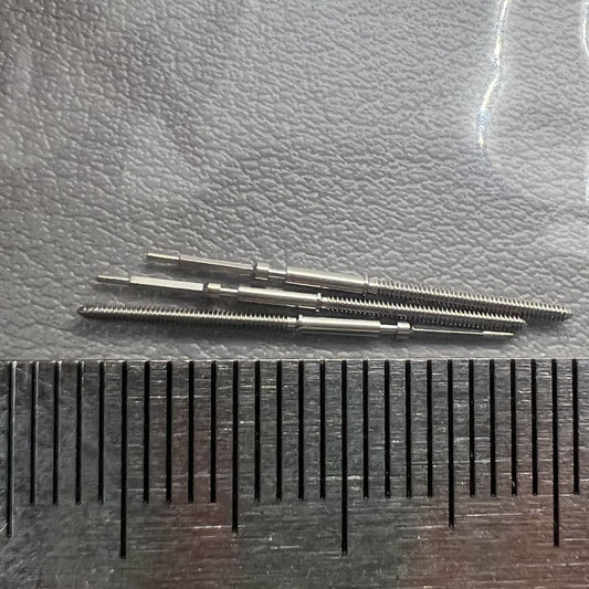 Set of 2 Swiss watch winding stems compatible with Ronda 7004 movement for precise time adjustments.