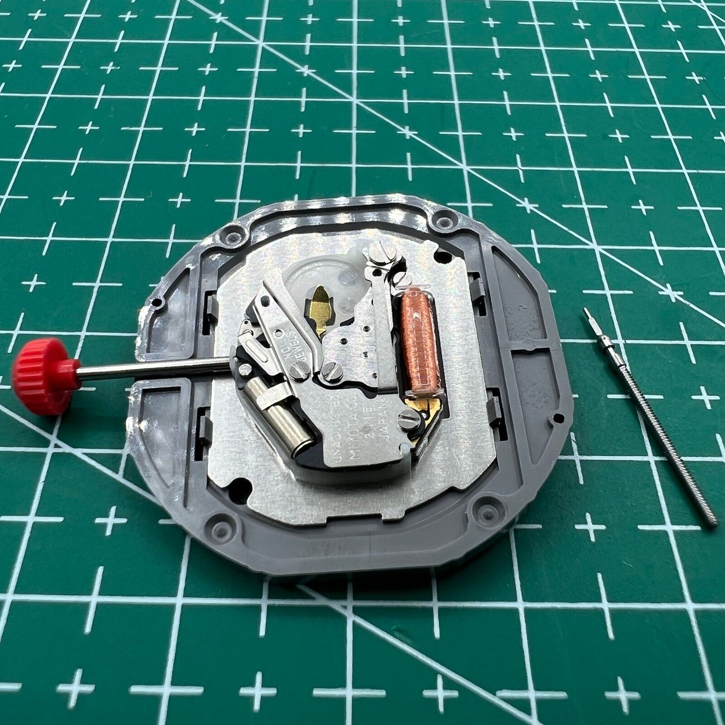 Miyota 2415 quartz movement watch part with black date disk at 3 o?clock, authentic Japan-made accessory.