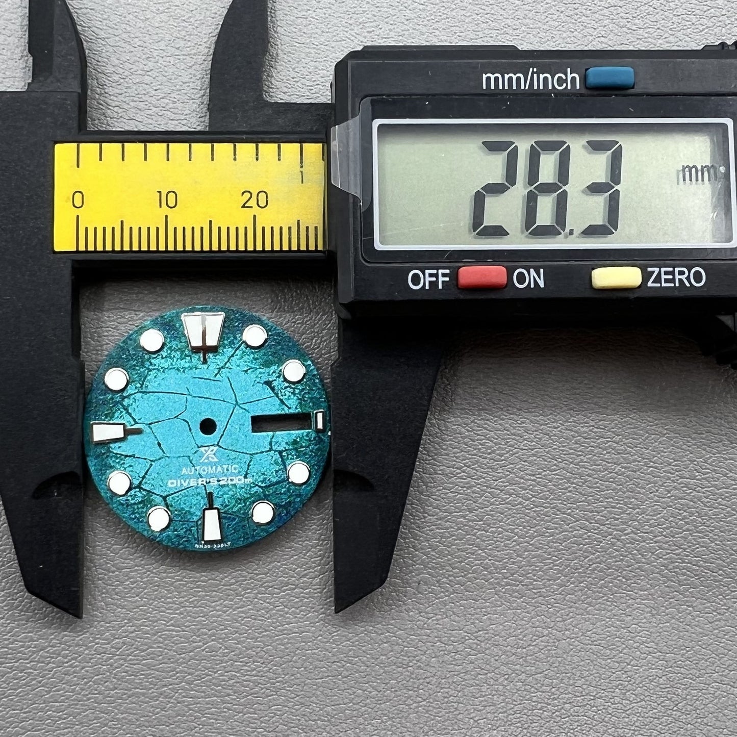 Blue diving watch dial with green luminous markers, compatible with NH35/NH36 movements for accuracy.