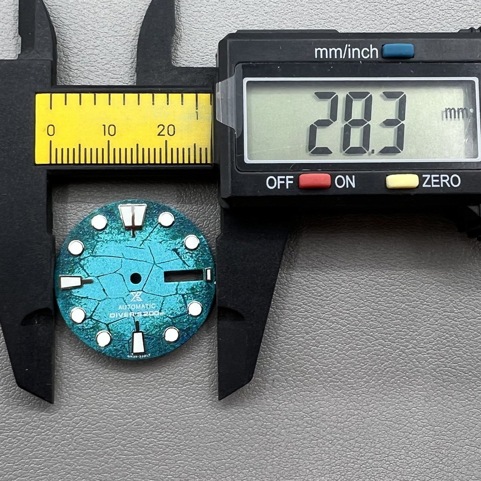 Blue diving watch dial with green luminous markers, compatible with NH35/NH36 movements for accuracy.