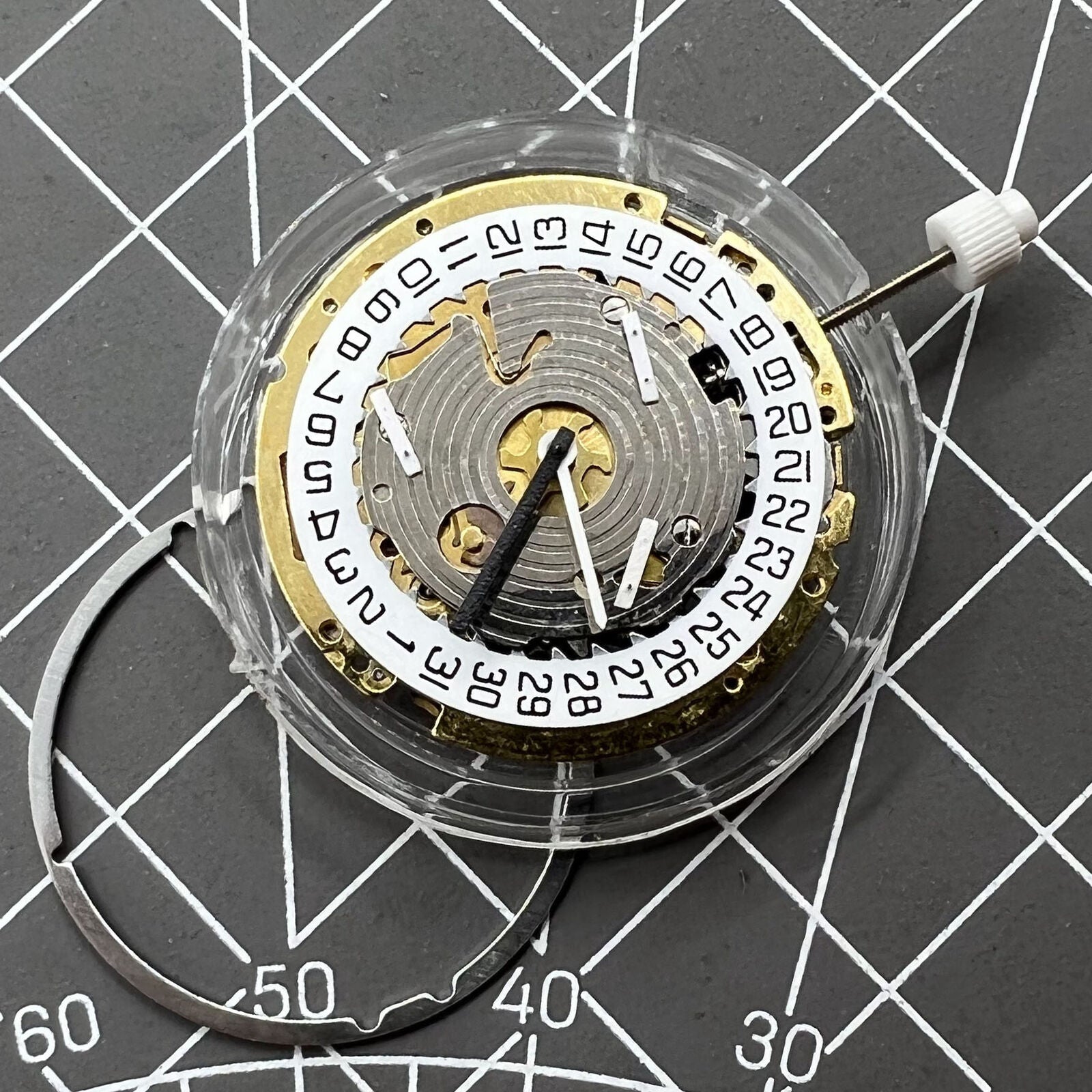 ISA 8171 Swiss made quartz watch movement with date at 4 and 6 hands on white dial.