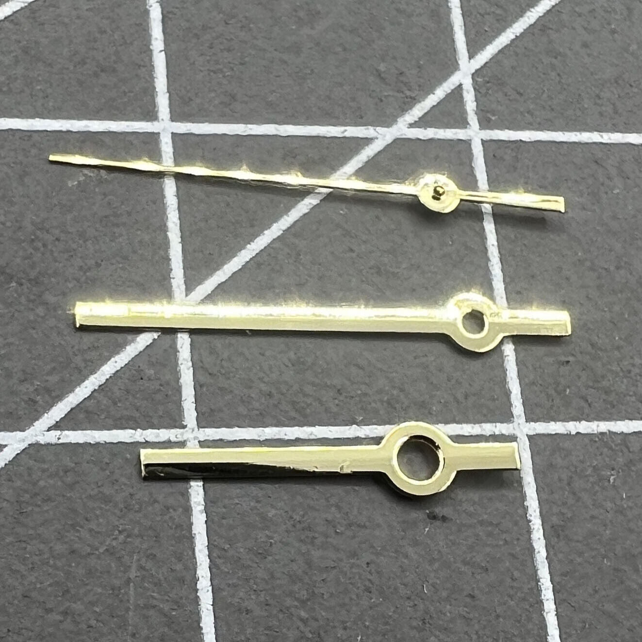 Golden polished 12mm watch hands set for Ronda 515 quartz, sleek and precise for elegant watch repairs