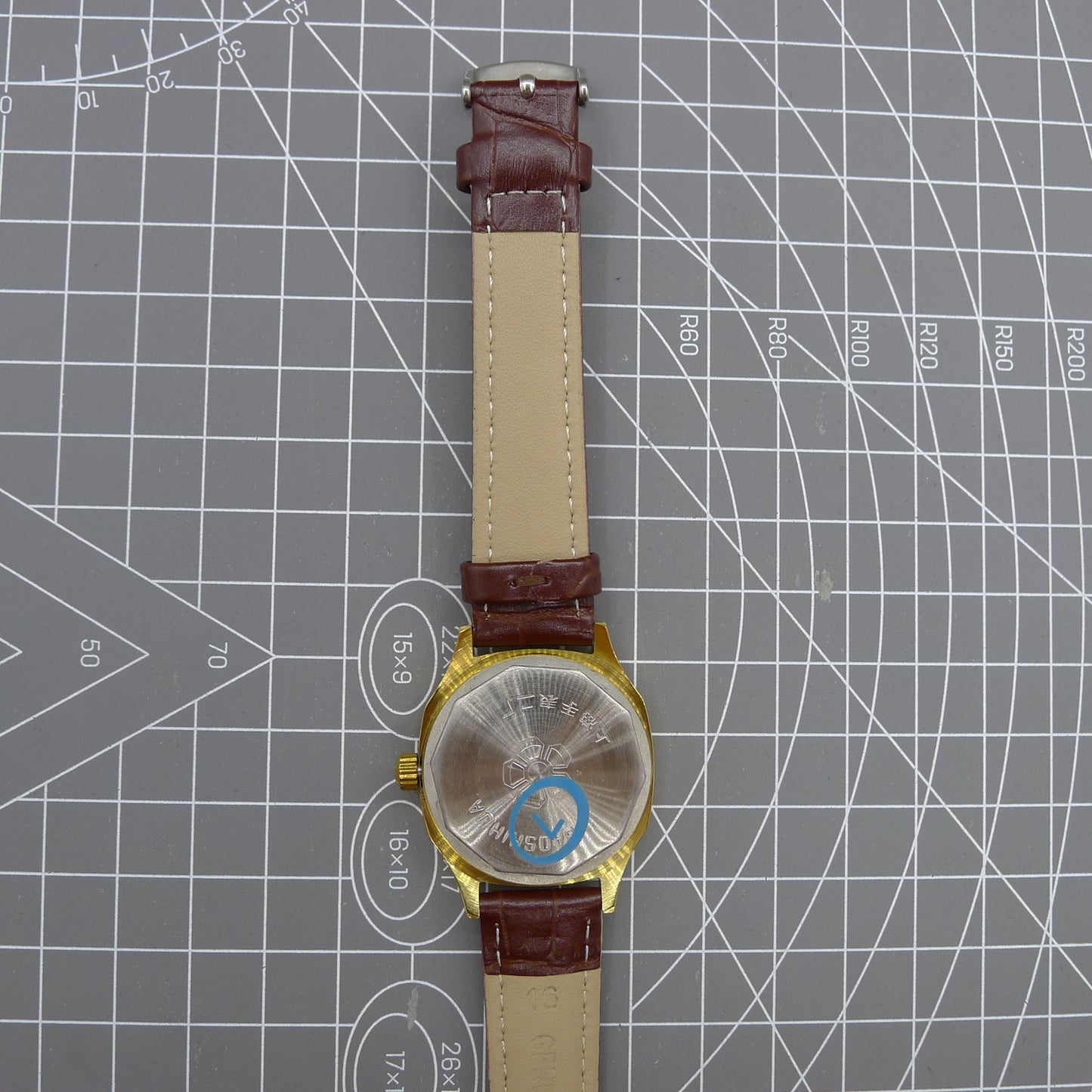 Shanghai 33mm manual mechanical watch with blue dial, golden markers, square case, 17 jewels movement.