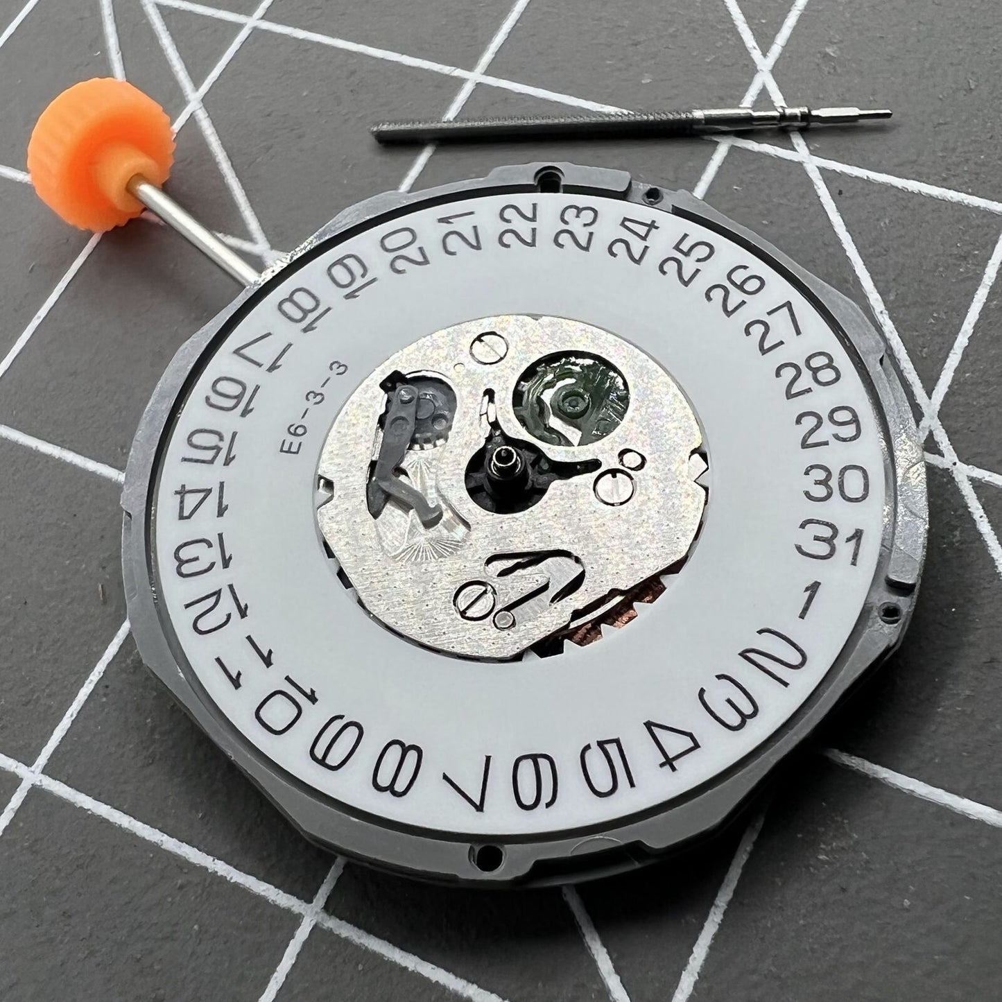 Miyota 1M12 quartz watch movement with date display at 3 o'clock, precise Japan-made mechanism.