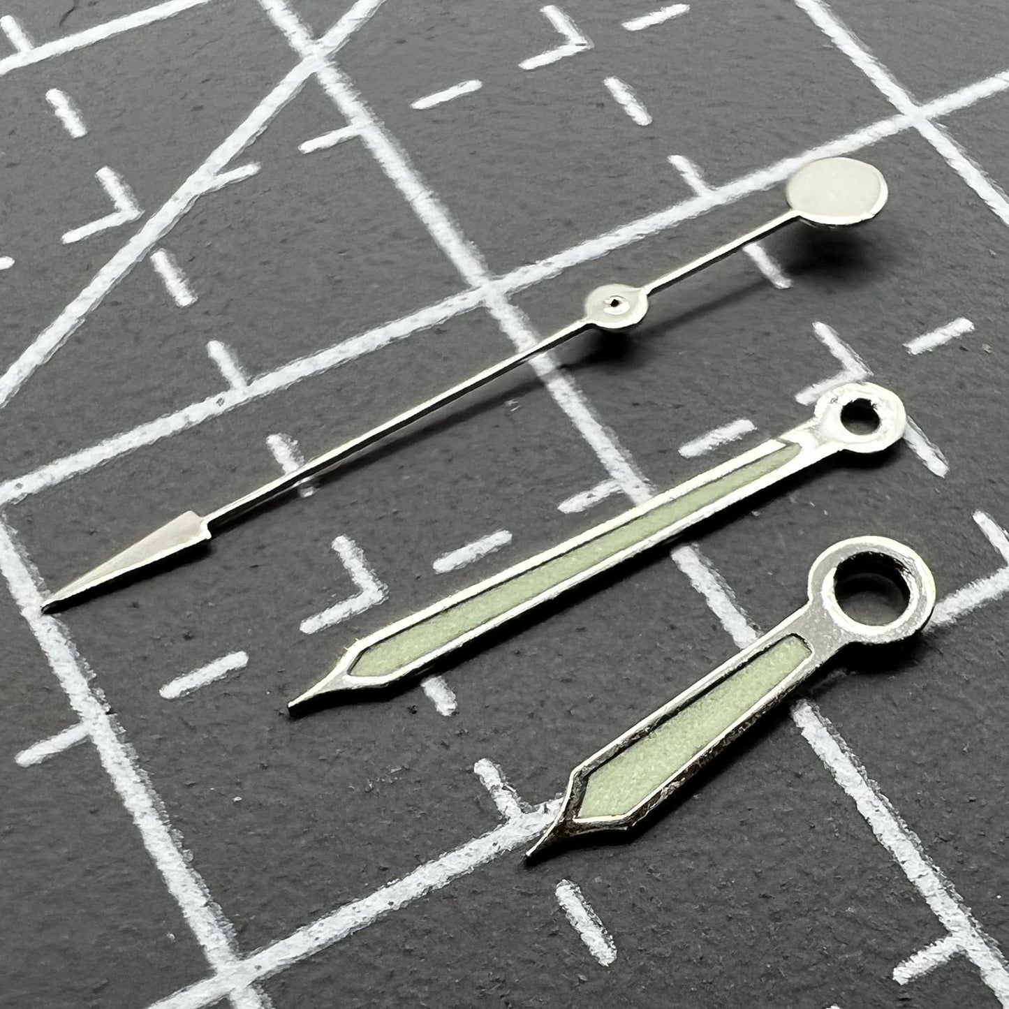 Green luminous watch hands with silver trim for Miyota 2035, 2115, 2105, 2305, 2315 movements.