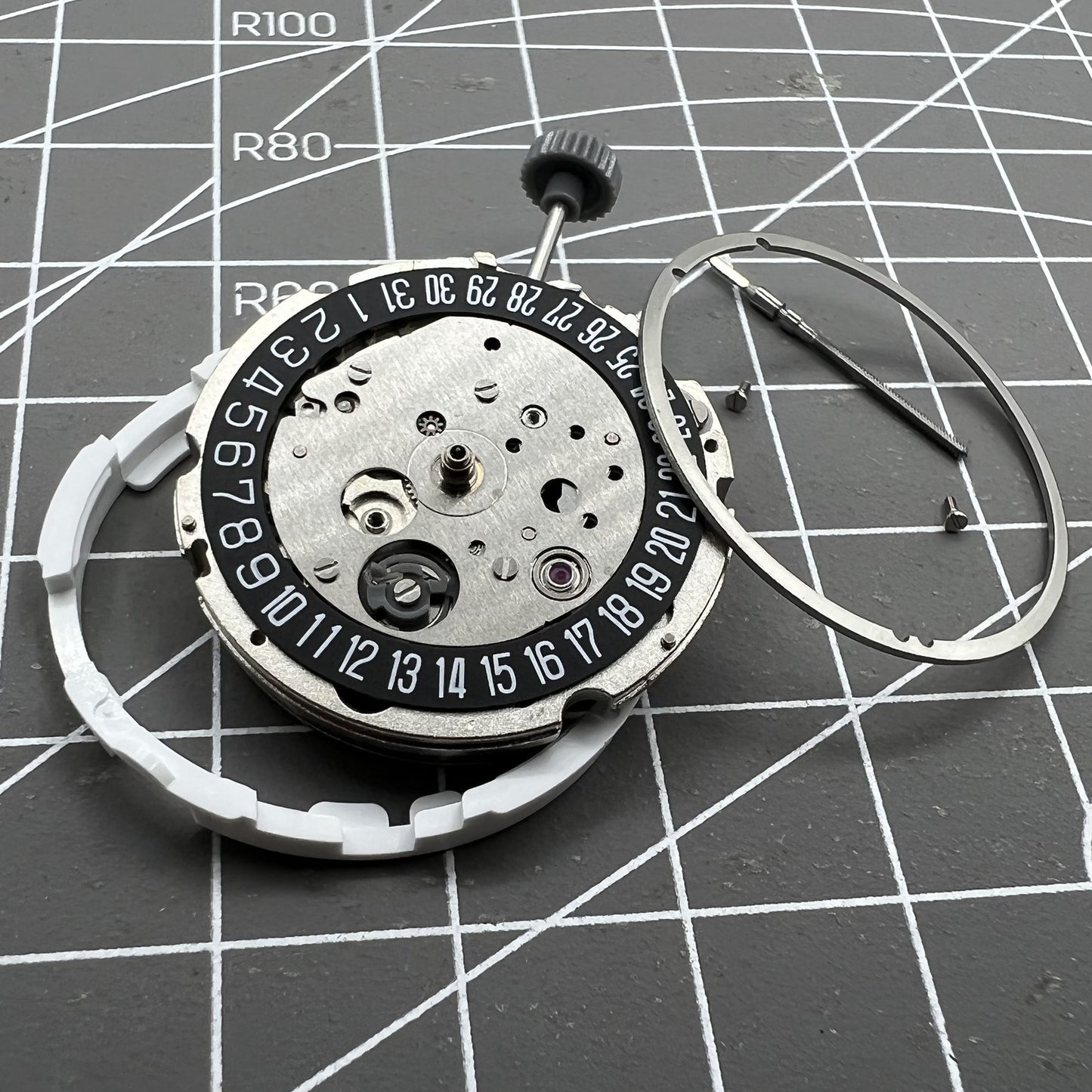 Miyota/Citizen 8215 watch movement with black dial and date at 6, automatic mechanical for precision timekeeping.