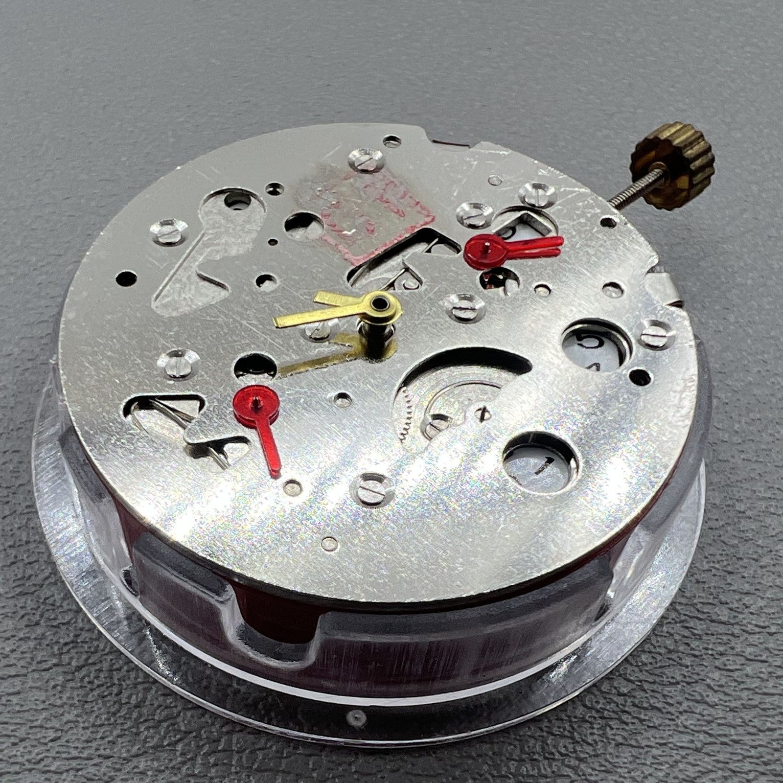 China Made 7120 watch with mechanical movement, second hands at 3/6/9, date display at 3, sleek design.