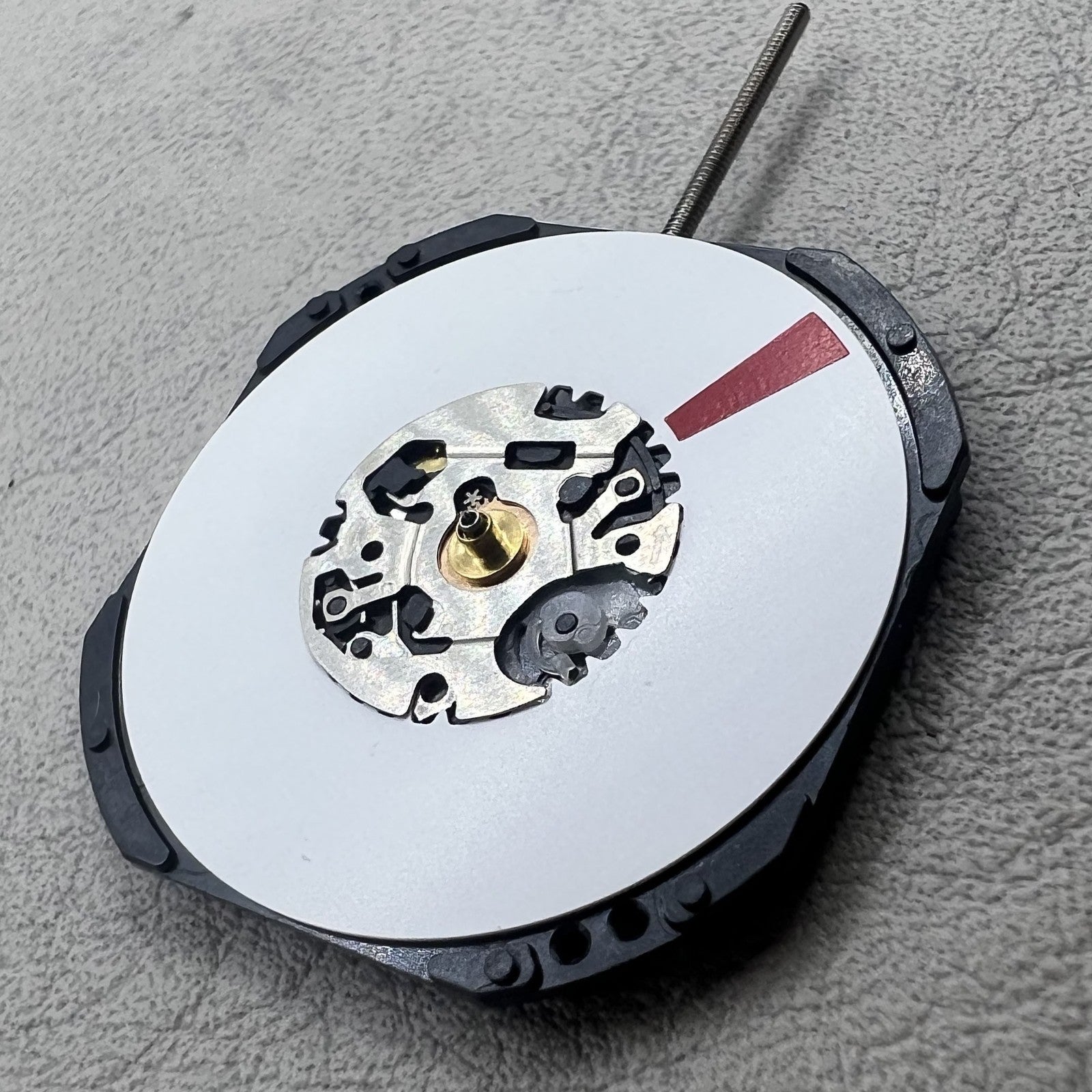 Japan Epson VX42.E quartz watch movement with 3 white hands showcasing precise timekeeping technology.