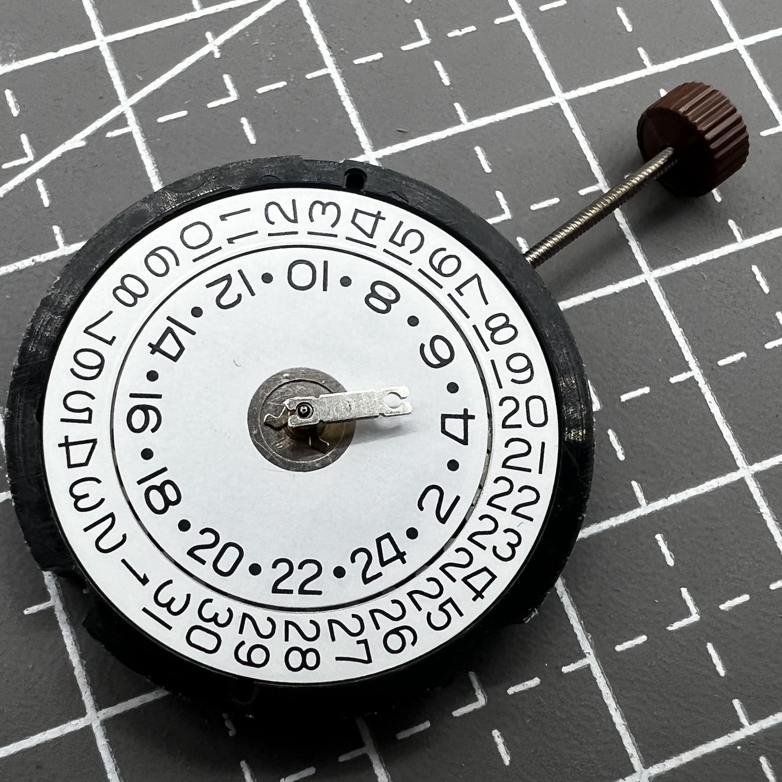 Ronda 505 24D quartz watch movement with date window at 3 o'clock, precise Swiss timekeeping mechanism.