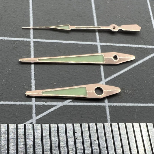 14mm rose gold arrow-shaped luminous watch hands for ISA 2331, green glow, precision accessory.