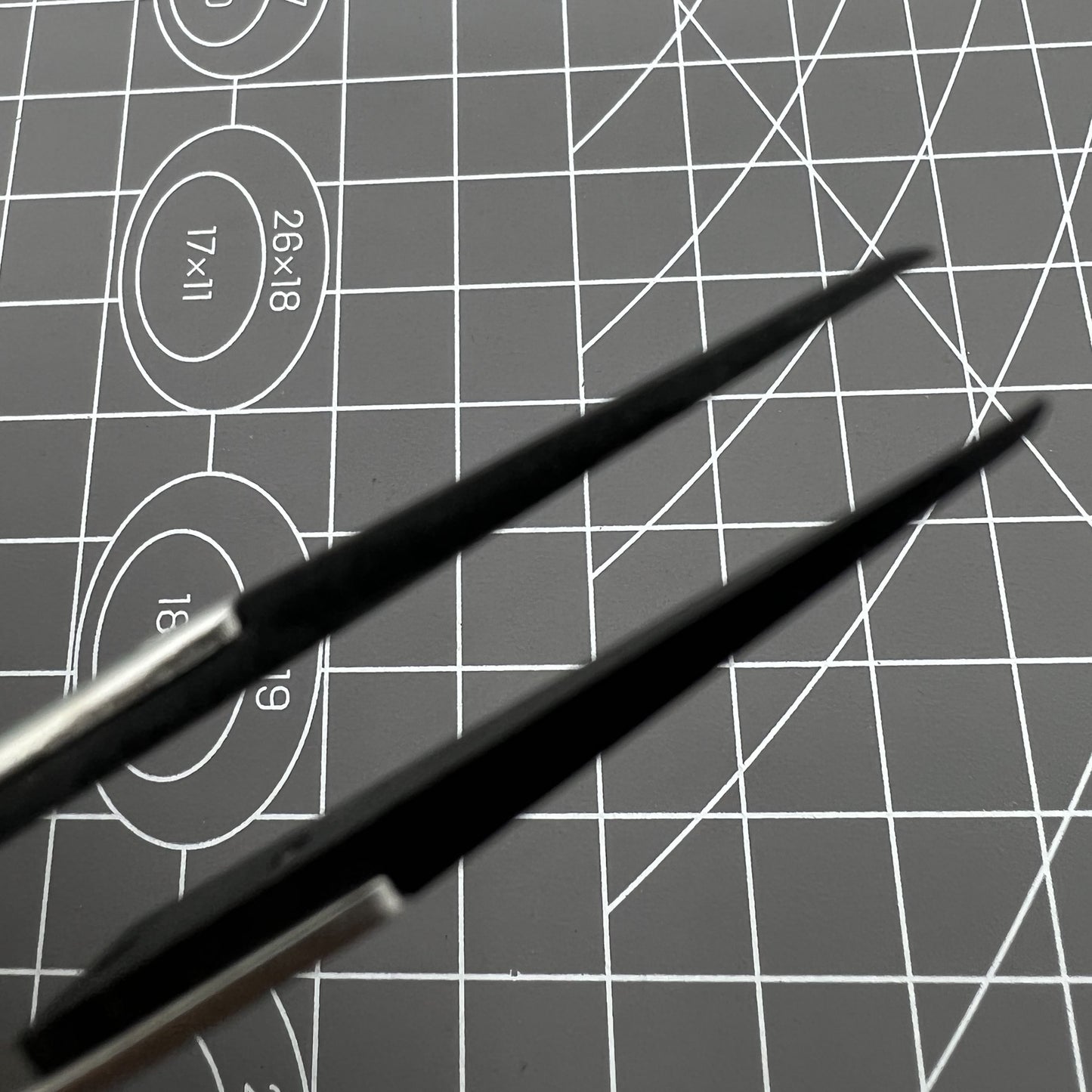 Stainless steel carbon fiber tweezers for precise watch repair and delicate accessory handling.