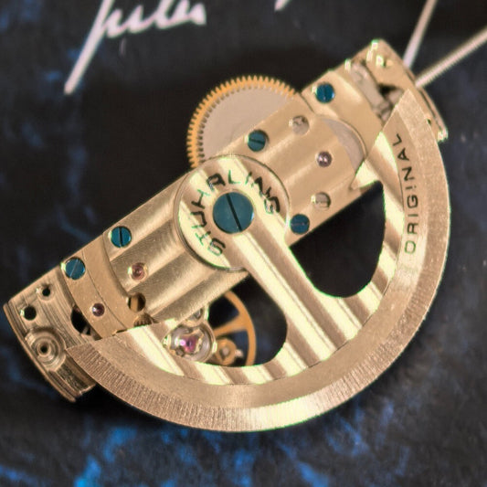 China Made Silver Kunlun hollow automatic watch part showcasing intricate mechanical movement details.