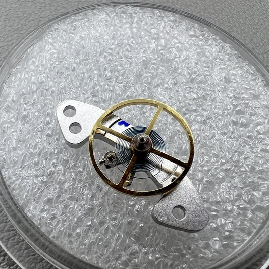 Blue mainspring mounted on complete balance wheel for Dandong 4130 mechanical watch movement.