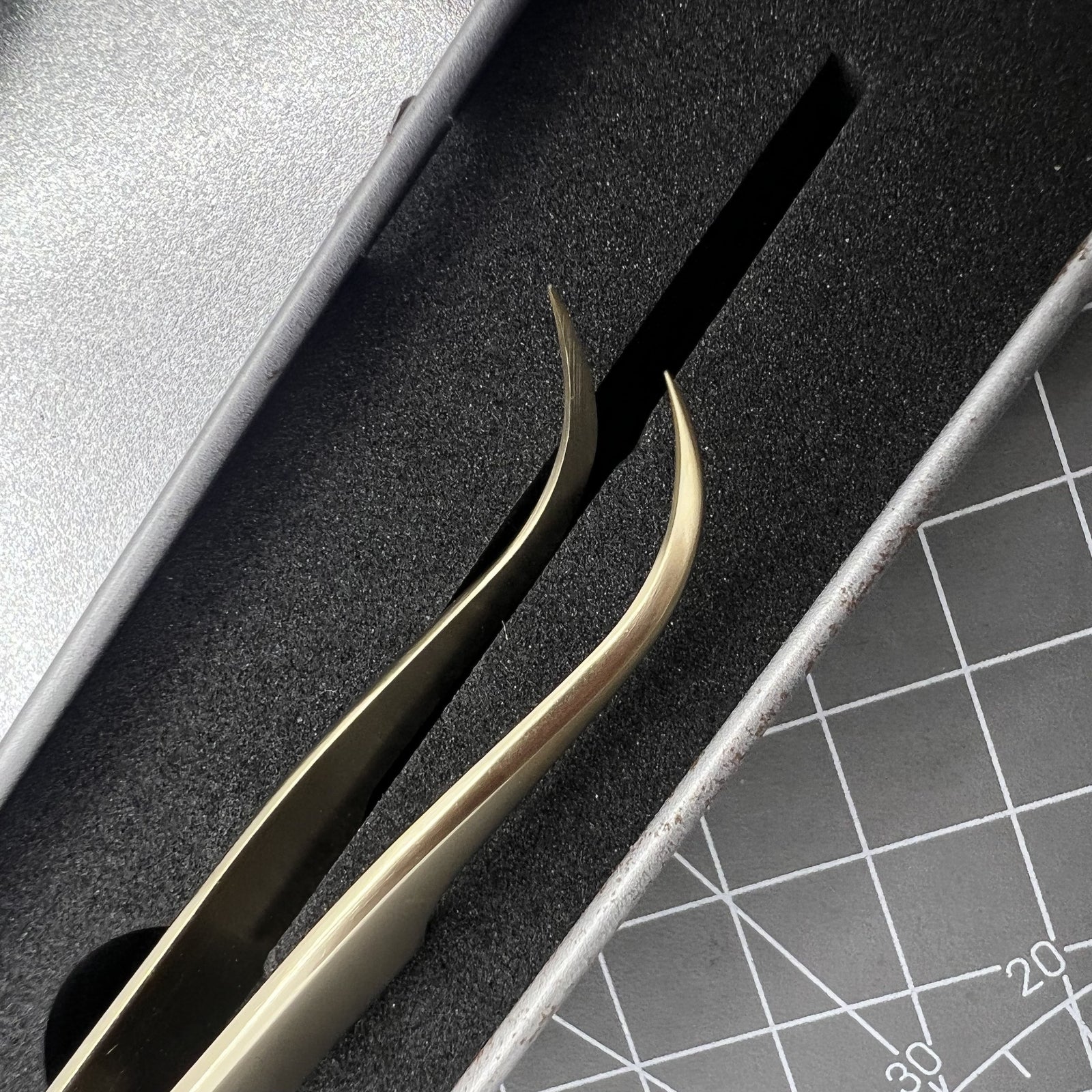 Golden curved elbow forceps stainless steel tweezers for precise watch repair.