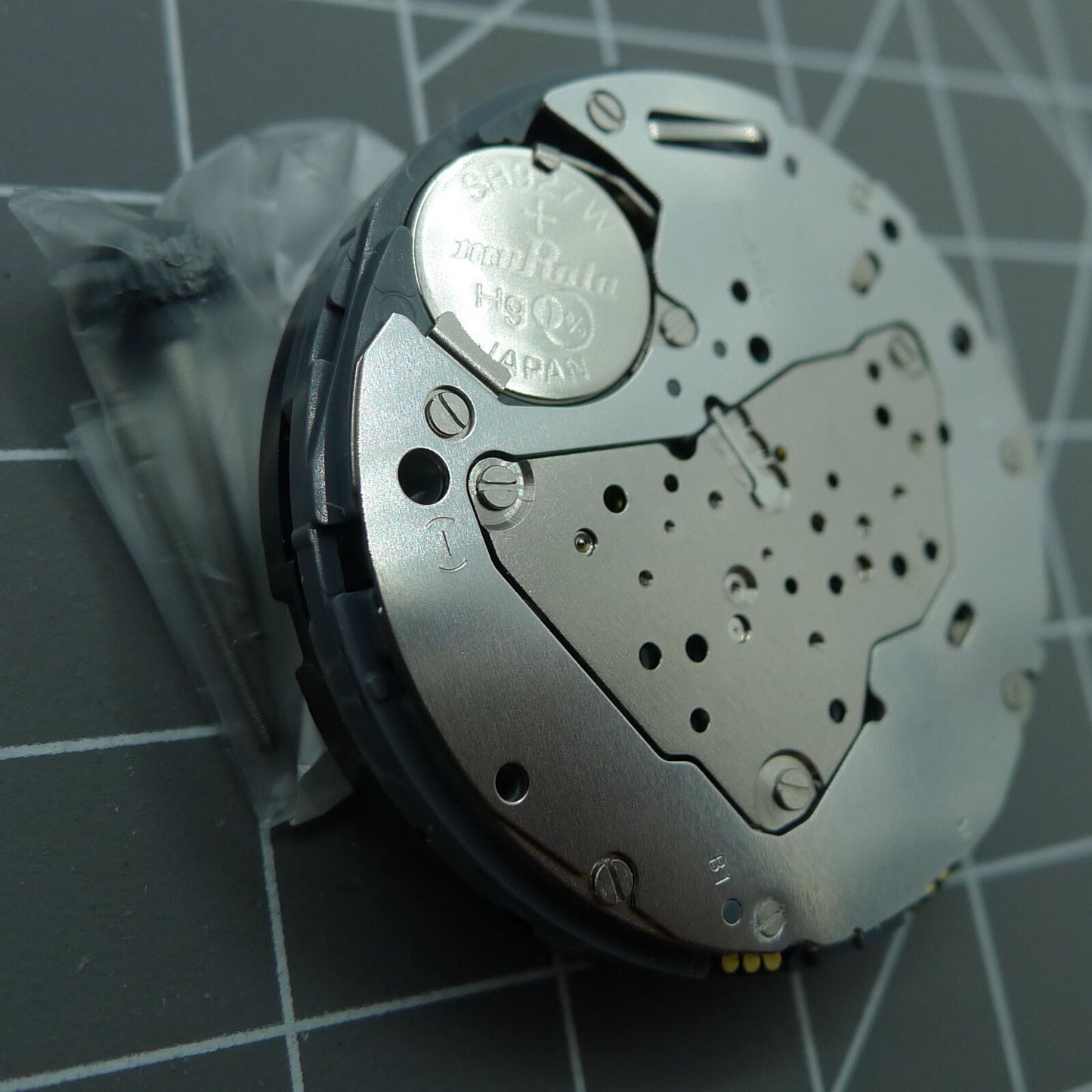 Miyota 6S50 quartz watch movement showing date at 12, three hands, and subdials at 3, 6, 9 positions.