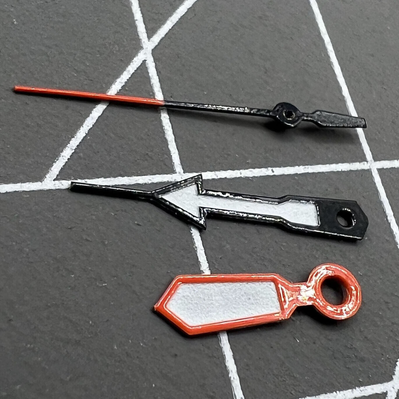 White watch hands with orange and blue trim for Miyota 2315, 2035, 2036, 2115, 2305 movements.