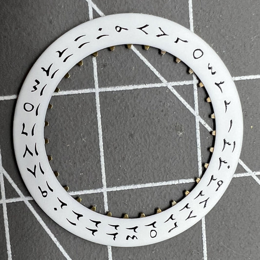 White background close-up of Arabic date disk wheel for ETA2824 Datejust watches, precision component.