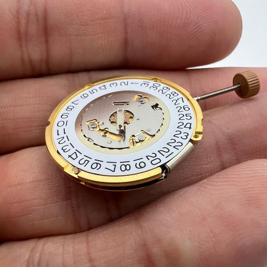 Ronda 6004D quartz watch movement with date display at 3 o'clock, precision timekeeping component.
