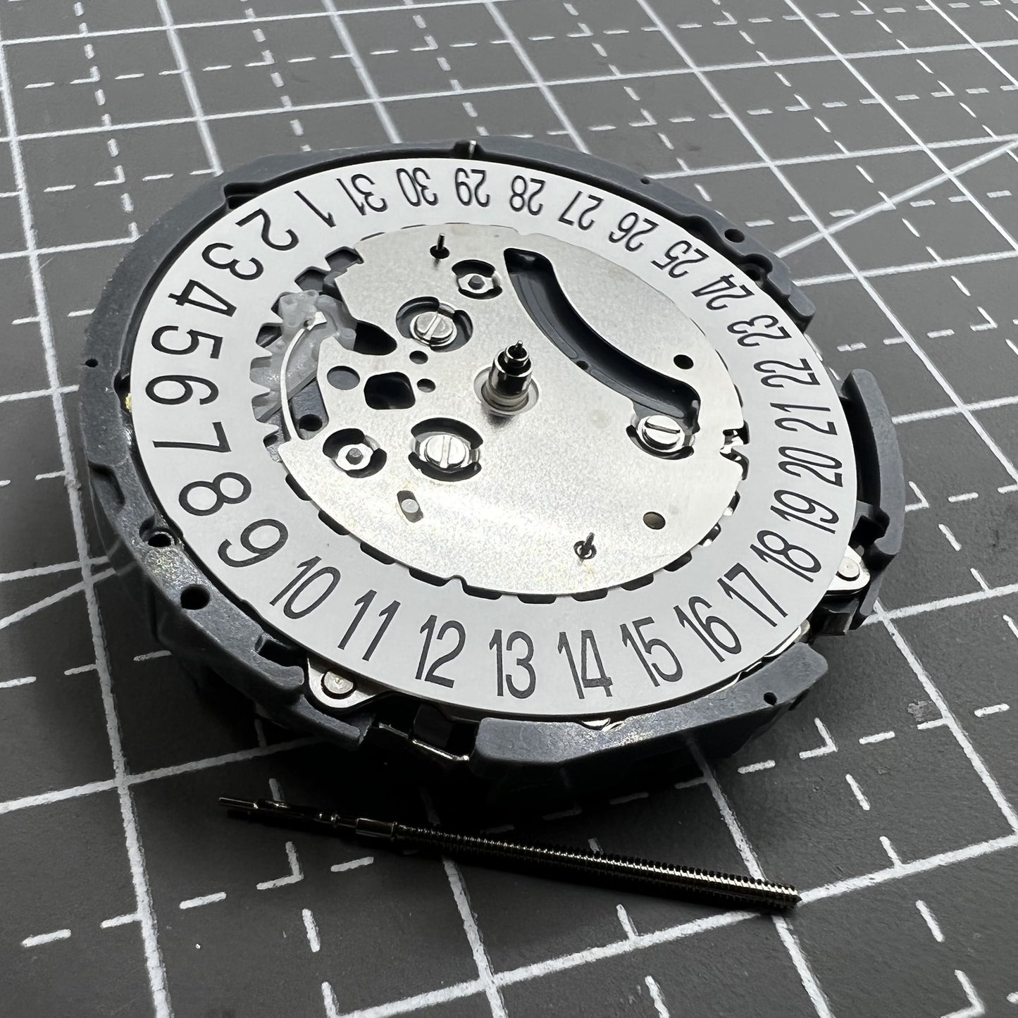 Japan Hattori VK64A quartz watch movement with date at 6 o'clock for precise timekeeping.