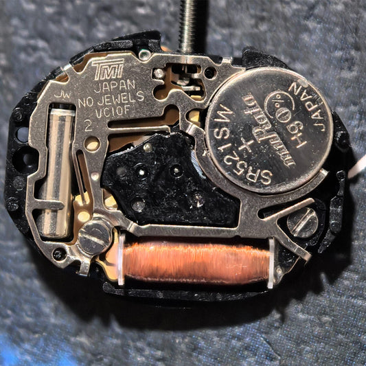 TMI VC10F quartz watch movement with 2 hands, Japan-made precision part for watch repairs.