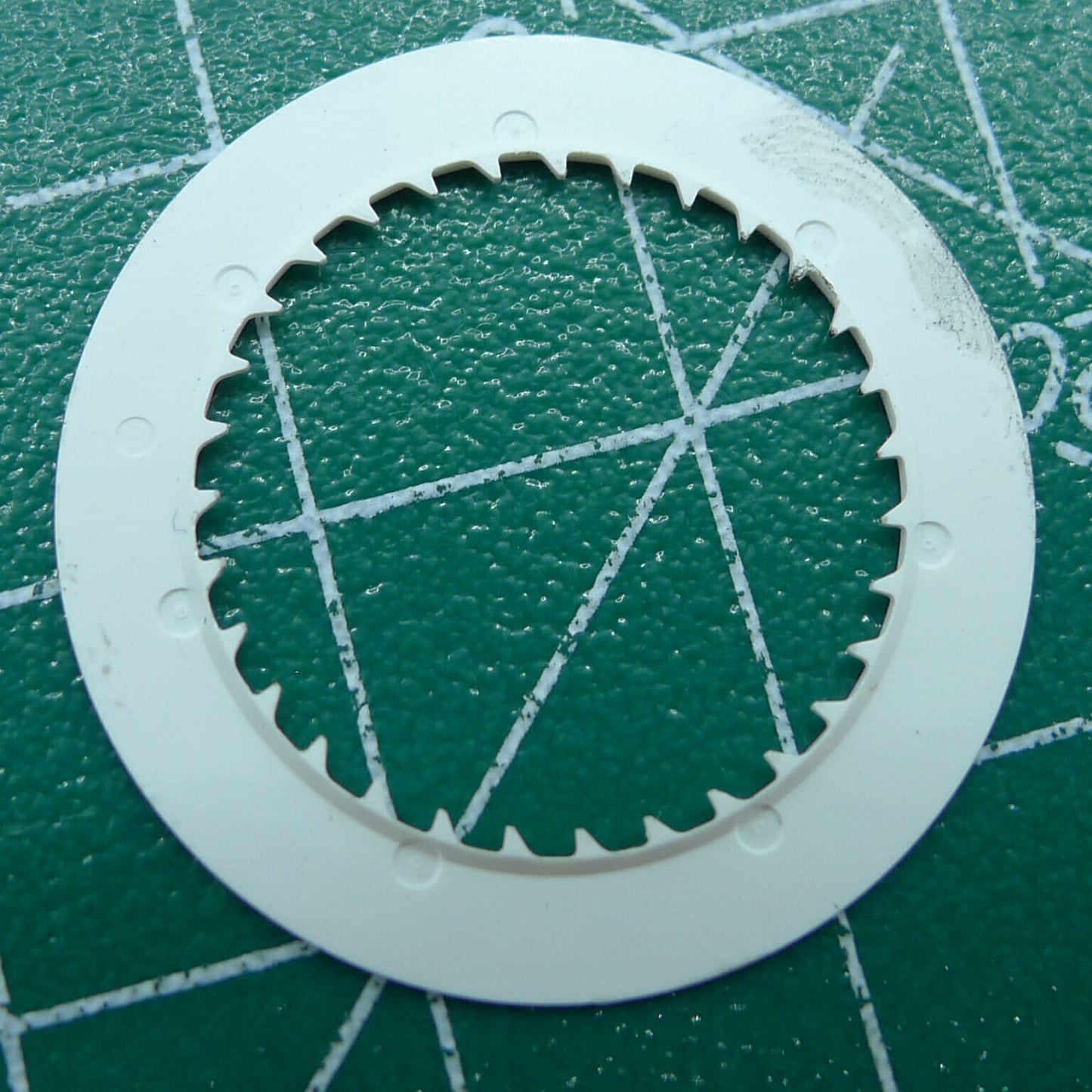 Green NH35 date disk on black background, improving date clarity and precision for watch movement.