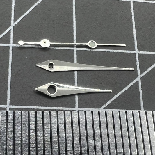 13mm silver arrow-shaped watch hands by Trim, compatible with Ronda 515 quartz movement, sleek design.