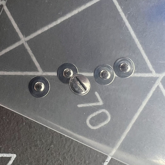 Silver screws securing the rotor oscillating weight for China Made 7750 watch movement components.