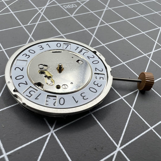 Ronda 6004B quartz watch movement with date display at 12 o'clock, precise timekeeping.