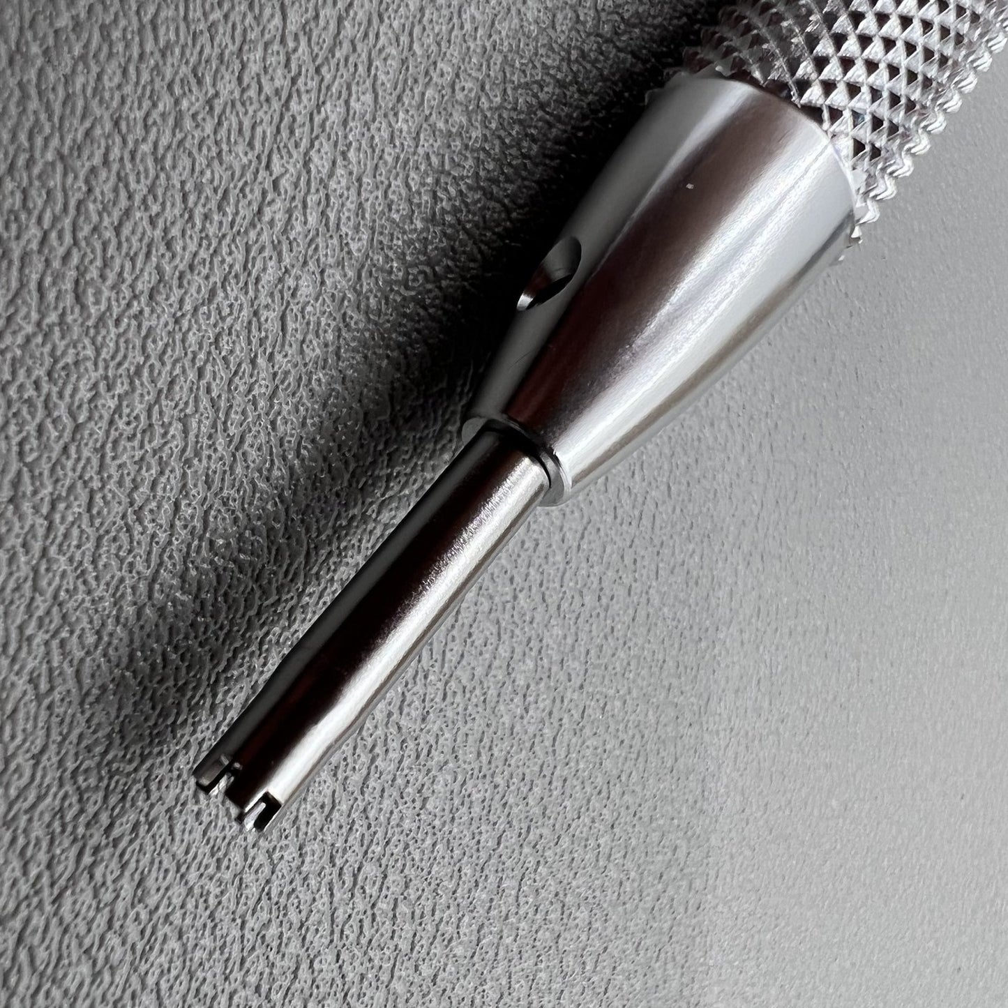 Prong spokes watch screwdriver for precise Richard Mille screw removal and case adjustments.
