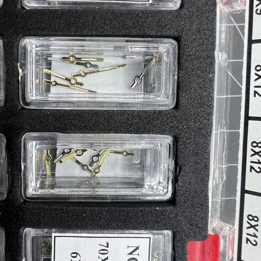 Golden and white luminous watch hands set for hour, minute, and second ? 44 sets for precise timekeeping.