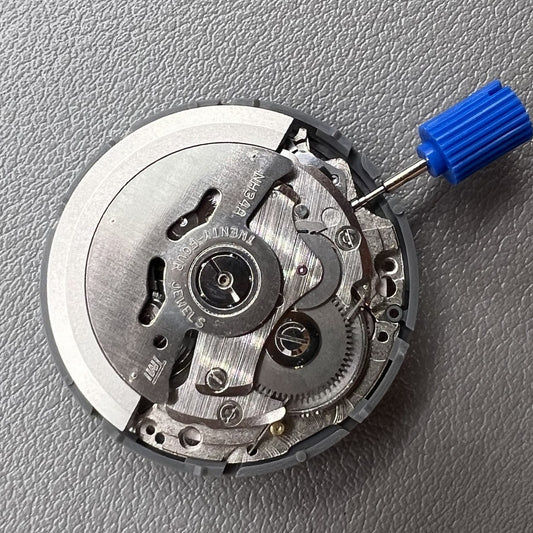 Seiko NH34 GMT watch movement with red disk wheel, automatic mechanical and hacking seconds.