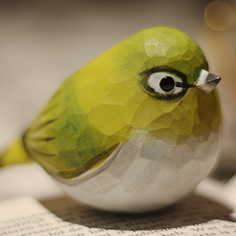 Handmade white-eye bird wooden figurine, perfect decorative accent for home or office shelves.