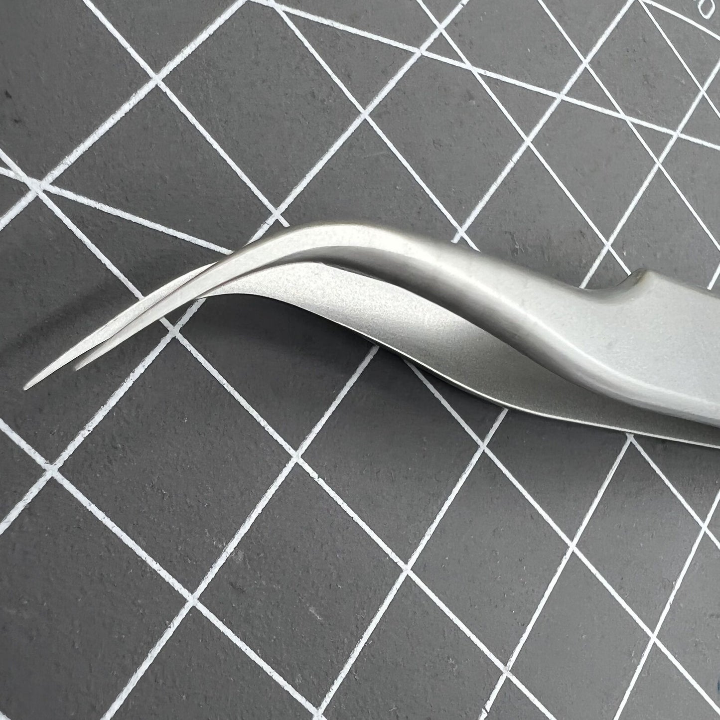 Swiss Bergeon 7026-7 antimagnetic tweezer with fine curved tips for precise watch accessory adjustments.