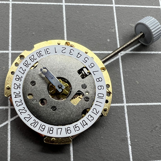 Golden Swiss Made Ronda 775 quartz watch movement with date at 6, precision timekeeping for accessories.