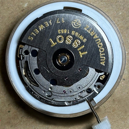 Swiss Made ETA 205.111 watch movement with silver finish, kinetic energy mechanism for precision timekeeping.