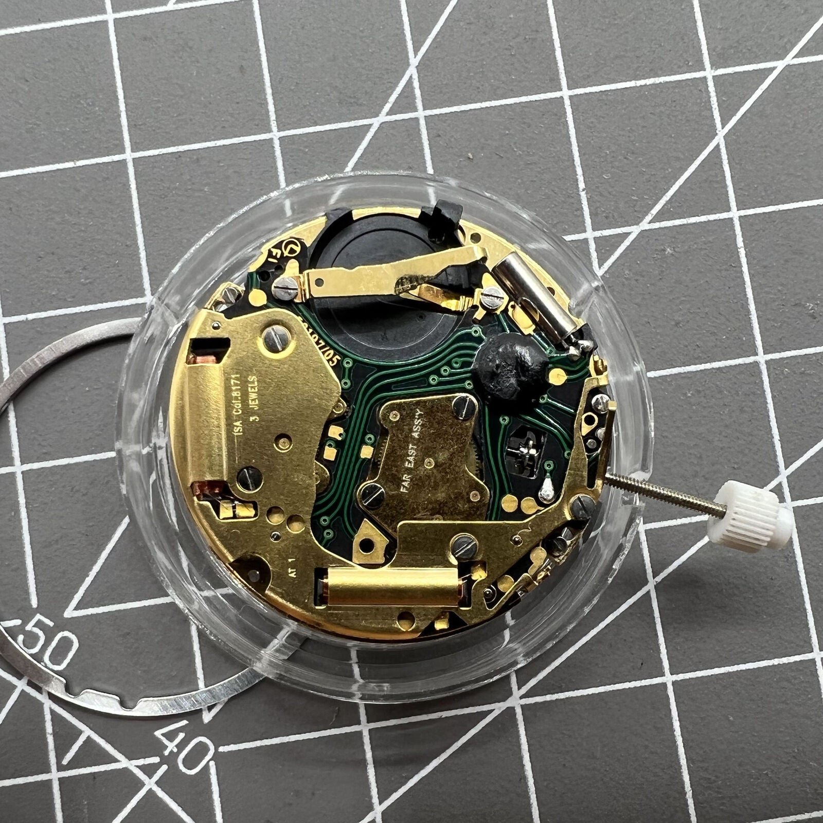 ISA 8171 Swiss quartz watch movement featuring date at 4, six hands on white dial for precision timekeeping.